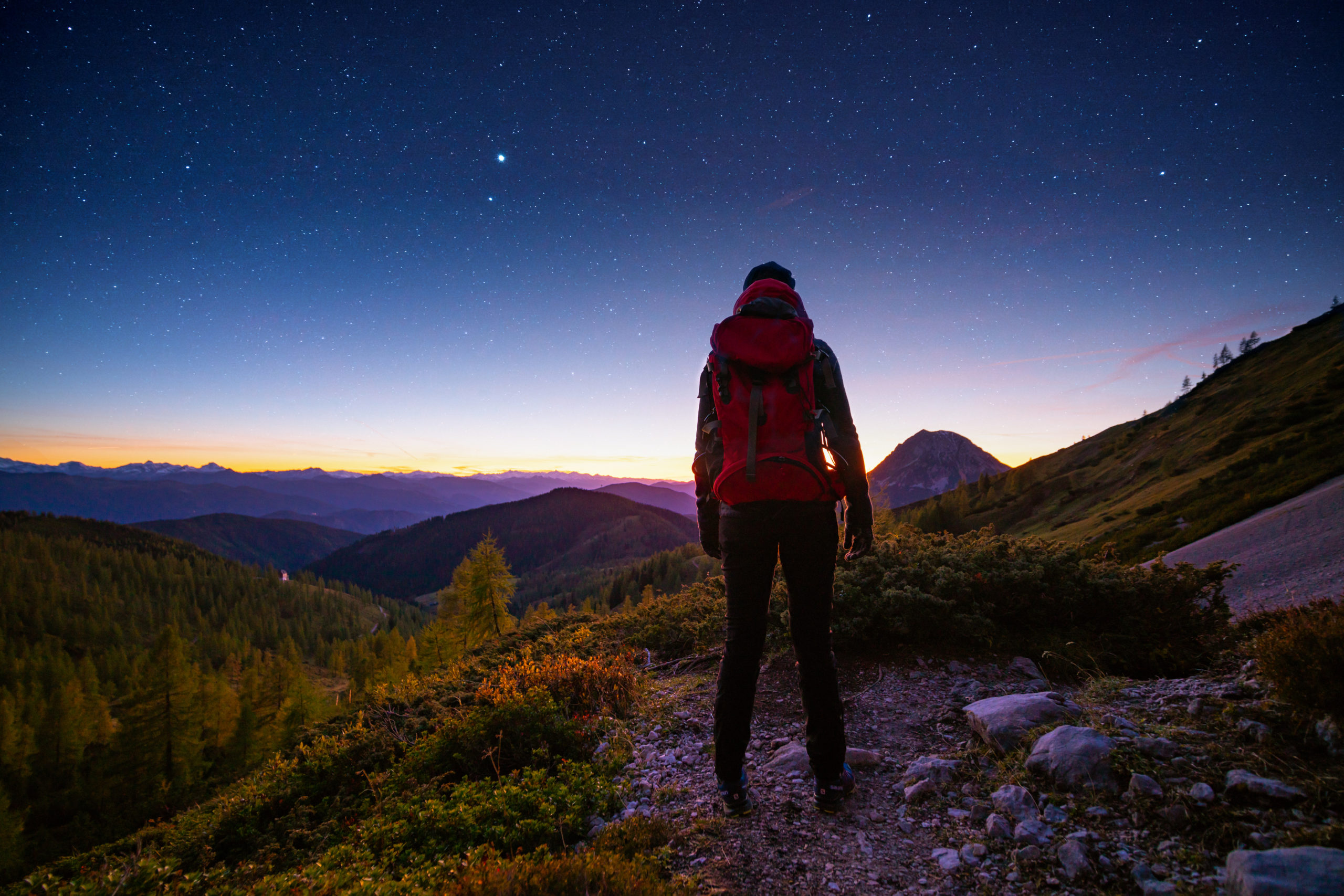 Hiker looking at stars for self-care