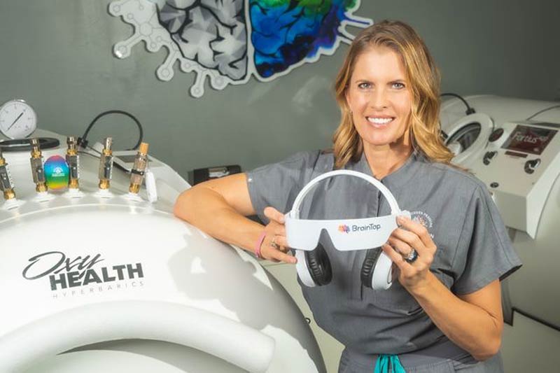 Janelle holding the BrainTap headset